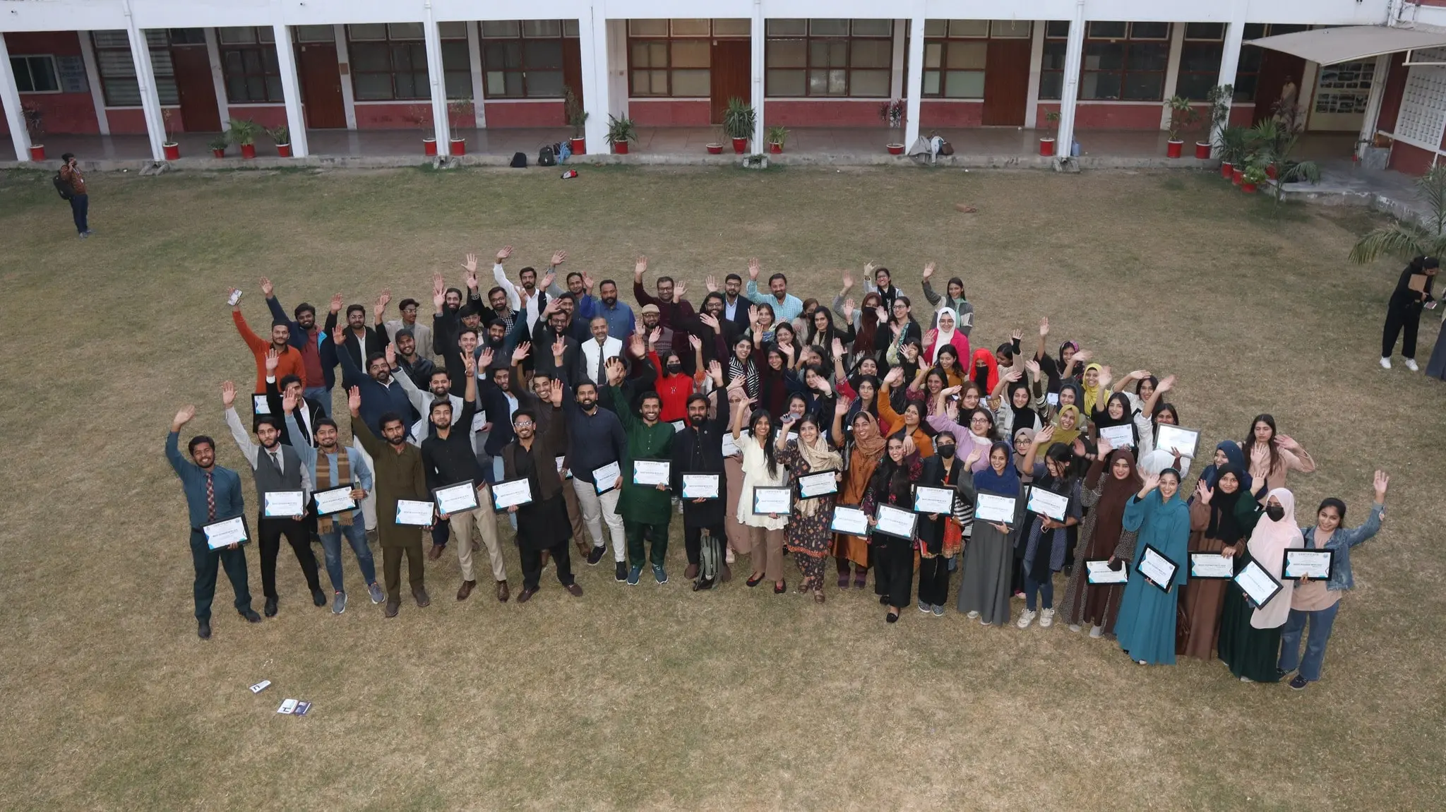 Students waving hands